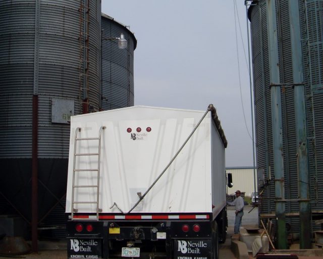Truck delivering shelled corn to grain bins