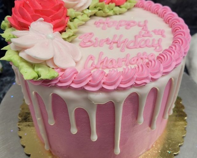round layered pink drip birthday cake